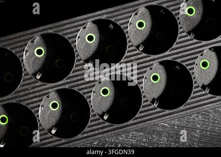 power filter extension cord on black wood background Stock Photo