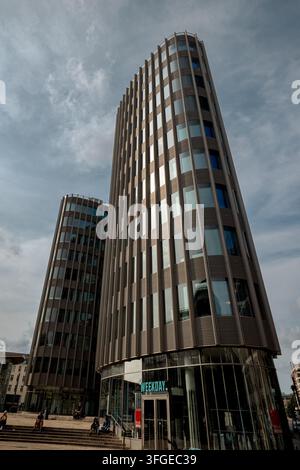 Modern high-rise building with Motel One signage rises above the street near Museum Island in central Berlin. Stock Photo