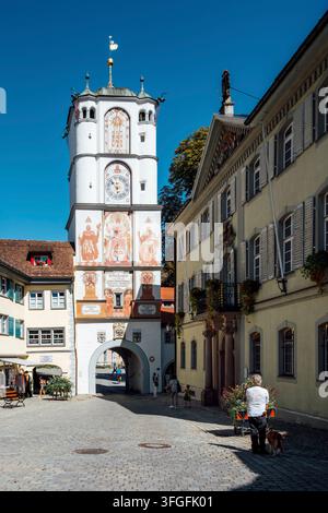 Pedestrian zone in a historic old town with traditional architecture, a cobblestone path and the historic Ravensburger Tor, also Frauentor at the end Stock Photo