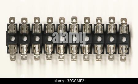 Multi-pole break-apart glass tube fuse block on white background directly above. Stock Photo