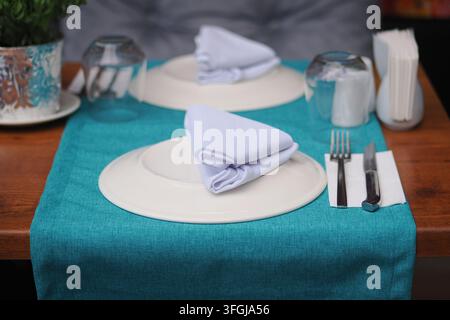 Table set with plates and utensils Stock Photo