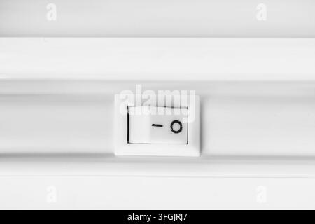 White plastic device switch toggle button closeup Stock Photo