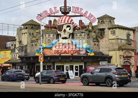 Colorful Coral Island pirate fortress facade with skull, sea creatures, cars, visitors. Stock Photo
