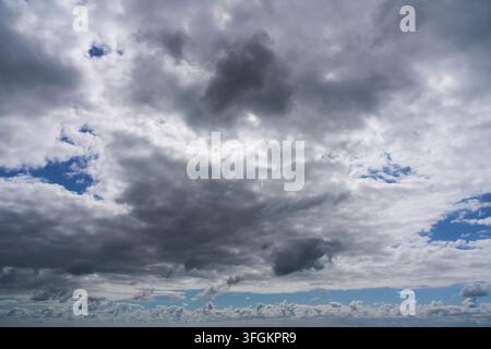 White clouds in blue sky with soft light over horizon Stock Photo