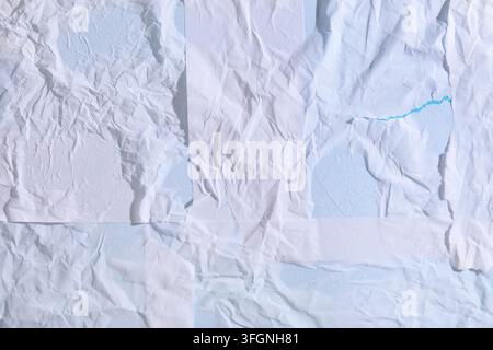 Collage and creative design, abstract background of layered white crumpled paper with torn edges and blue texture for artistic projects and graphic ar Stock Photo