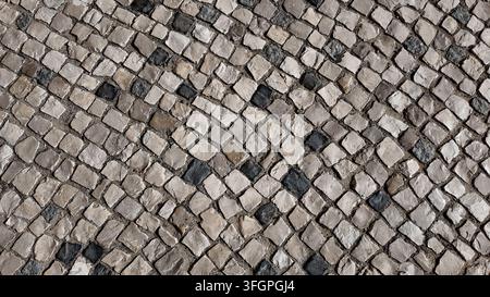 Traditional granite cobblestone pavement texture in Lisbon Portugal Stock Photo