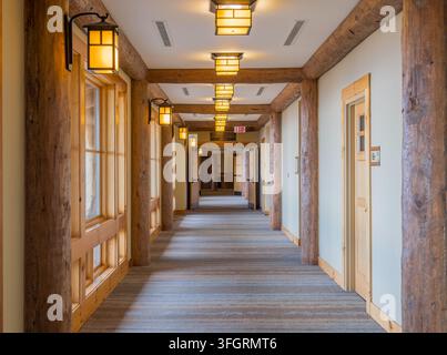 Arkansas, United States, SEP 05, 2026 - A long corridor features rustic wooden support beams, hanging lanterns, and carpeted flooring leading toward a Stock Photo