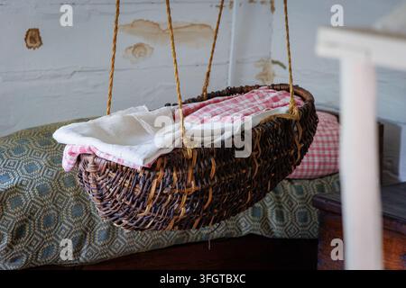 Traditional woven hanging cradle inside a rural historic house in Podlasie, Poland Stock Photo