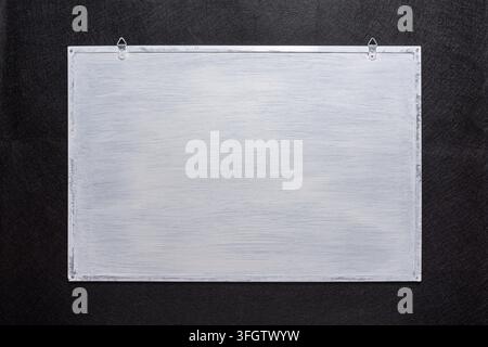 White board on black background. Surface for inscriptions Stock Photo