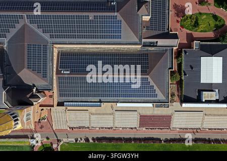 Transmission Array Aerial view of a large building with extensive solar panel arrays on ...