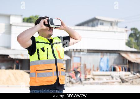 Modern Construction Worker Uses Virtual Reality for Inspecting Project Planning evaluation safety progress VR on building Site. Stock Photo