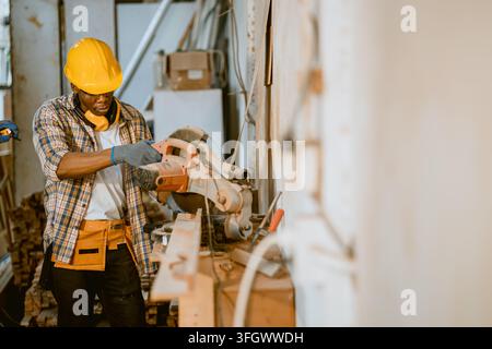 Male Carpenter Operating Electric Circular Saw Cutting Timber Plank on Workbench Inside Furniture Factory Workshop Power Tool Stock Photo