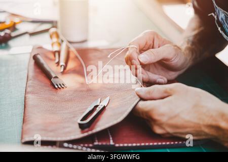 Leather Craftsman Stitching Handmade Bag In Artisan Leathercraft Workshop Male Craftsman Hands Sewing Leather Goods Material Using Needle Thread Awl P Stock Photo