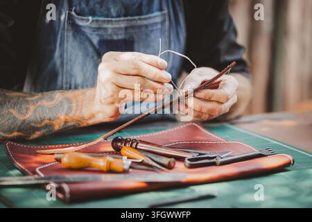 Leather Craftsman Stitching Handmade Bag In Artisan Leathercraft Workshop Male Craftsman Hands Sewing Leather Goods Material Using Needle Thread Awl P Stock Photo