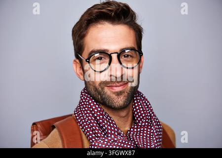 Happy, man and educator in studio with portrait, career pride and about us for education guidance. Professional, person and professor with glasses Stock Photo