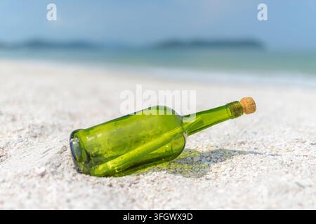 Message in a bottle (MIB) on a sand beach Stock Photo