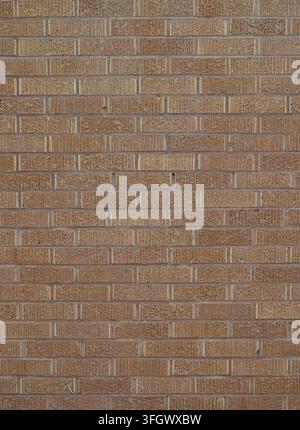 Closer view of brown textured brick wall with vertical grooved bricks, smooth mortar joints, chipped brick faces and assorted brown brick variations Stock Photo