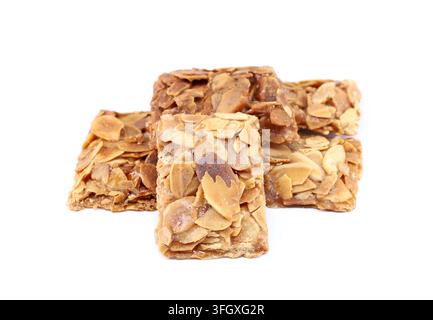 Pieces of almond crunch or almond brittle, traditional italian dessert, on white background. Stock Photo