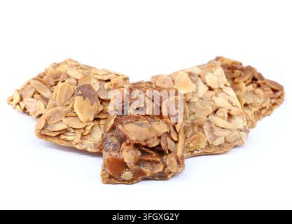 Pieces of almond crunch or almond brittle, traditional italian dessert, on white background. Stock Photo