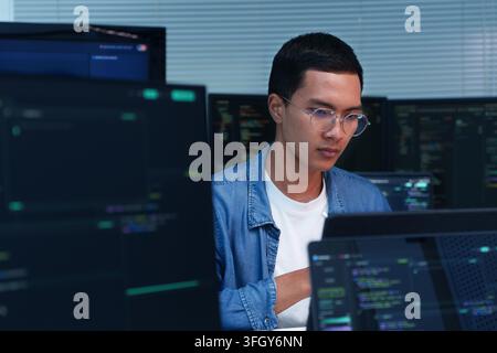 Young programmer focused on software development, coding, artificial intelligence, and digital technology projects. Stock Photo