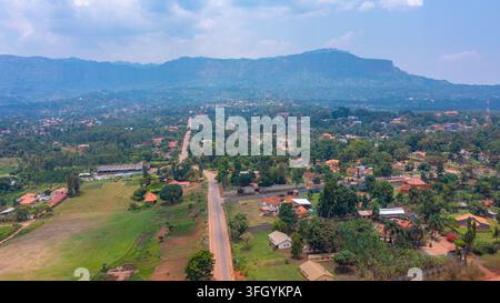 Aerial view of the Senior Quarters neighborhood with a road through lush residential areas, scattered houses, and the Mount Elgon range in the backgro Stock Photo
