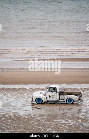 Vintage white hot rod pickup truck number 152 driving on Bridlington South Beach at Race to the Waves 2026 Stock Photo