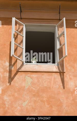 A wide-open window on a colorful facade in Mala Strana, in Prague's Old Town Stock Photo