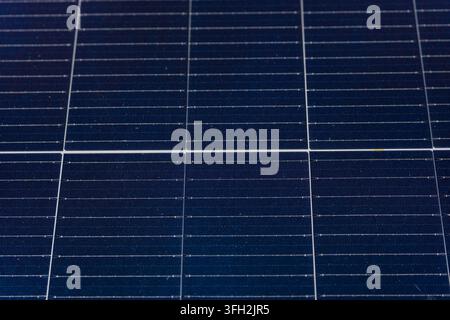 Close-up of dark blue photovoltaic solar cells with fine conductive lines and a geometric grid pattern on a solar panel . High quality photo Stock Photo