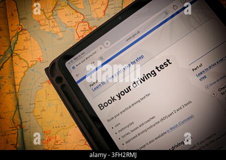 Official GOV.UK driving-test booking page displayed on a tablet in Scotland, illustrating the online process for booking a practical test. Stock Photo