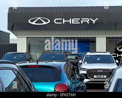 Invicta Chery dealership in Warrington with new Chery SUVs, including the Tiggo range, lined up outside the branded showroom, Chinese marque's dealer Stock Photo