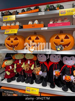 Halloween October merchandise and pumpkin decorations on a seasonal supermarket shelf under Star Buys promotional price labels. Stock Photo