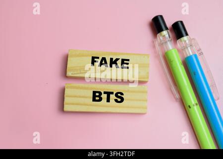 Concept of fake BTS text on wooden blocks. For telecom scam and fake cell tower Stock Photo