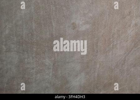 Full frame background of a warm grey polished cement wall texture, featuring fine hairline cracks, rustic details, and abstract plaster patterns Stock Photo
