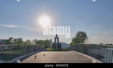 Minsk, Belarus - May 21, 2026: Stone pedestrian bridge over Svisloch river leading to monument of internationalist soldiers memorial complex at Island Stock Photo
