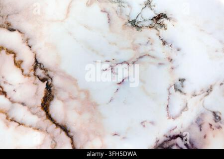 Close-up of polished white marble stone surface texture featuring natural intricate grey, brown, and dark purple veins and patterns. Stock Photo