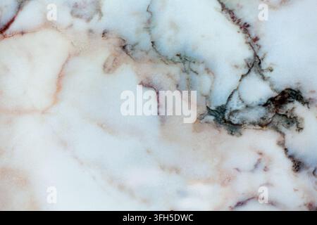 Close-up of a smooth white marble slab featuring natural grey and brown veins, highlighting organic texture and architectural design. Stock Photo