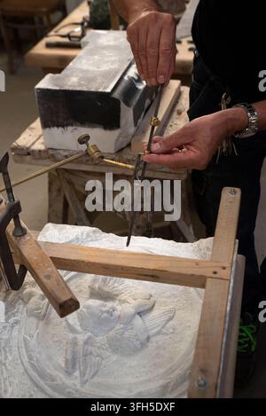 Using the pantograph to make a copy of a marble bas-relief. Master artisan at work. Stock Photo