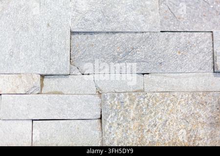Close-up of a dark black and brown polished marble stone surface featuring natural white veins and intricate abstract texture patterns. Stock Photo