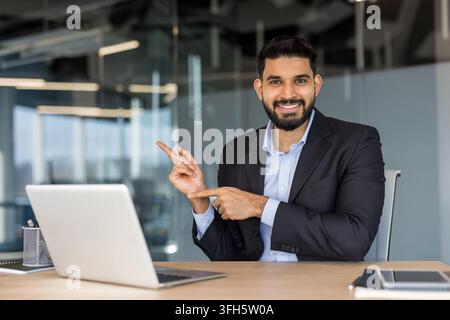 Professional businessman pointing at copy space. Stock Photo