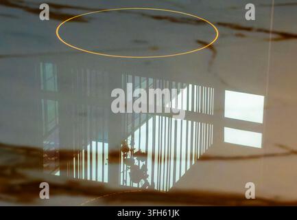 A  highly polished, reflective stone or marble surface featuring warm brown veining and a clear mirror-like reflection of an interior space with verti Stock Photo