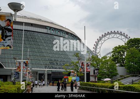 Tokyo, Japan - July 17, 2026: Tokyo Dome and the Big O Ferris wheel at Tokyo Dome City, with visitors, Yomiuri Giants advertising and the Thunder Dolp Stock Photo