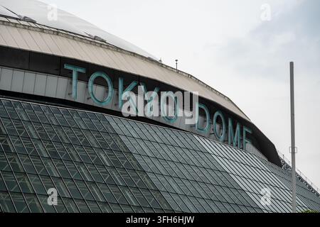 Tokyo, Japan - July 17, 2026: Close view of the Tokyo Dome exterior, with the large Tokyo Dome sign above the curved glass facade of the indoor stadiu Stock Photo