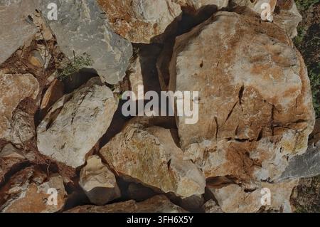 Croatia weathered limestone rocks stacked in rustic dry stone garden wall Stock Photo