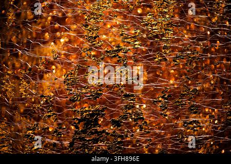 Golden nano texture in reflective gold surface. Golden shimmering backdrop for jewelry design. Golden glittering pattern on premium foil. Golden Stock Photo
