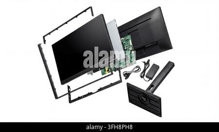An exploded view of a computer monitor, intricately disassembled to reveal its core components: the flat screen panel, the main circuit board with por Stock Photo