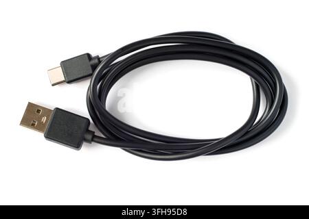 Black USB to USB type-c cable on a white background. Close-up of a coil of cable Stock Photo