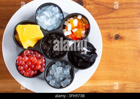 A top down view of a plate holding a variety of popular milk tea toppings and ingredients. Stock Photo