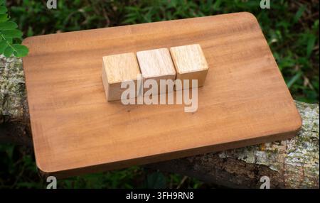 Three Wooden Cubes on Rustic Wooden Board Minimal Business Mockup Stock Photo