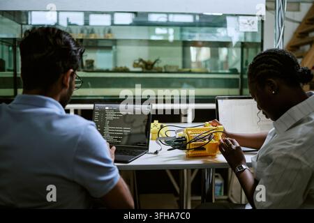 Diverse Engineers Coding and Testing Underwater Robotics in Laboratory Stock Photo