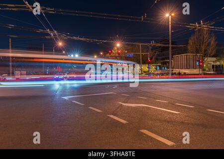 Light trails on busy intersection at night in Beijing Stock Photo